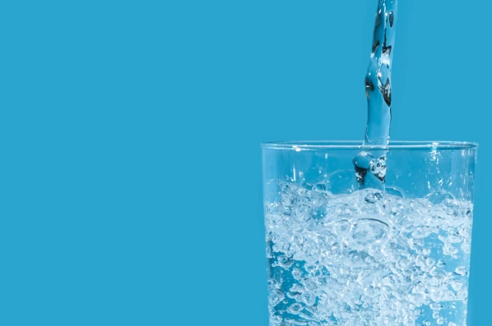 Glass being filled with water for drinking