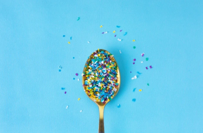 spoon filled with microplastics